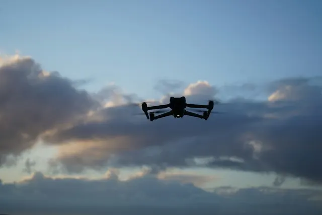 Survey drone flying against the evening sky